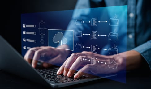 Hands on laptop orchestrating cloud storage and data access across optimized infrastructure.