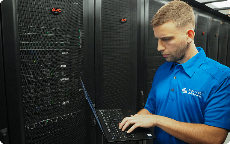 ServerMania technician configuring an AMD EPYC 4124P dedicated server in a secure data center.