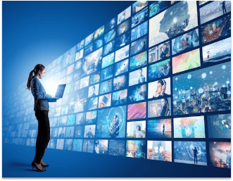 women on tablet in front of a wall of screens