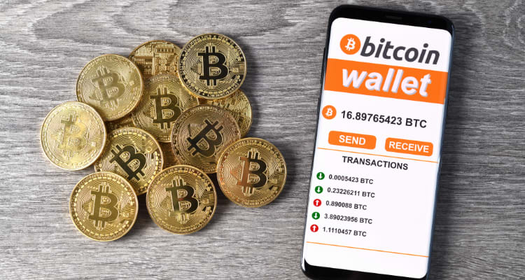 physical coins with bitcoin logo with iphone