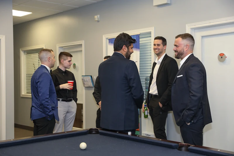 Candid shot, employees gathered in an office